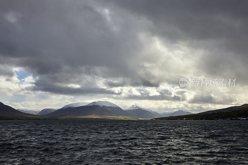 Eyjafjörður fjord with mountains and dark cloudscape in North Iceland